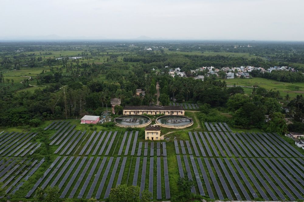 Aerial view of a solar farm surrounded by farmland