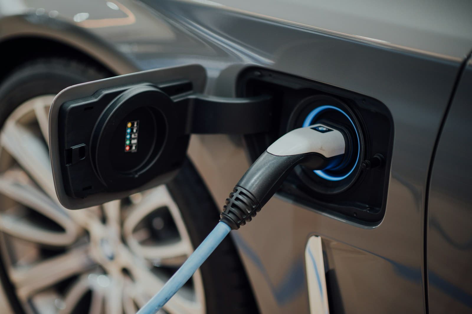 CCS2 connector seated in the charge port of a parked car