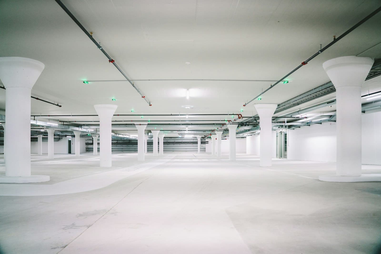 Bright column-lined commercial parking deck ready for charger installation