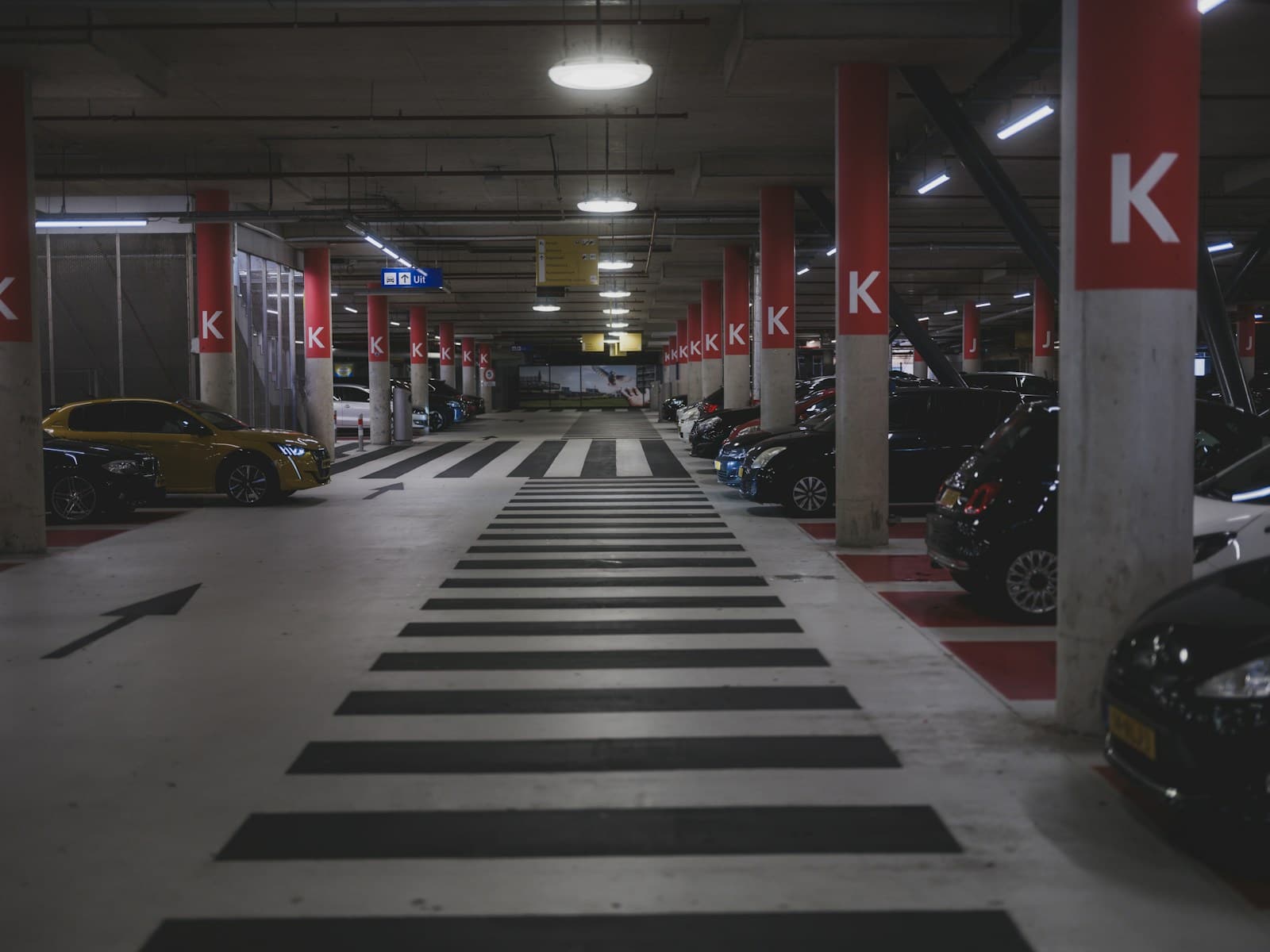 Underground car park with marked walkway and lettered support columns
